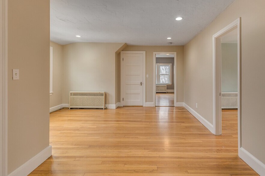 Bright living room with classic hardwood floors and an open feel. - 5 Larchmont Rd