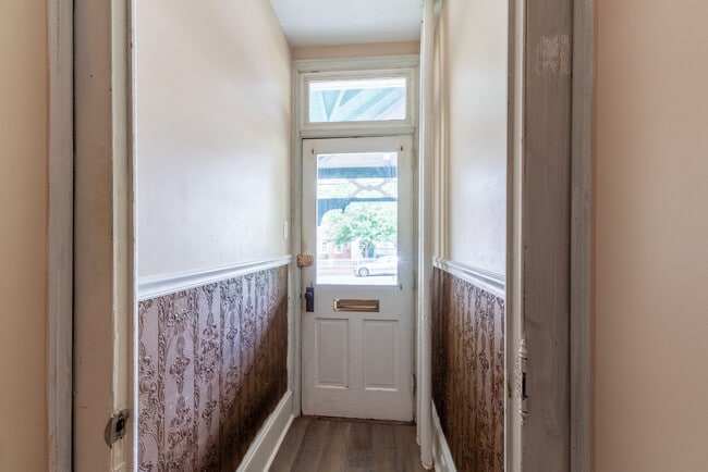 Front door view from entrance hallway, leading out to the front porch. - 506 Washington St
