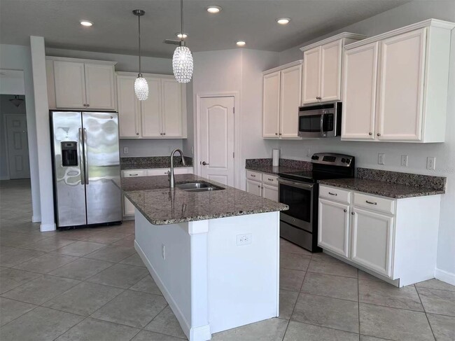 Building Photo - "Spacious 5-Bed Retreat with Elegant Hardw...