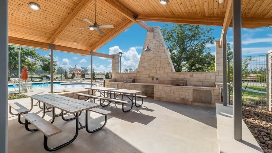 Community Pool with Covered Pavillion and outdoor picnic area with grills - Photo credit TM Homes - 12112 Coyote Call Way