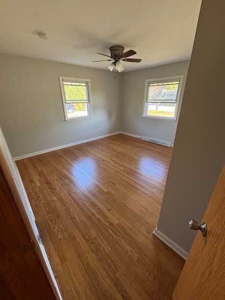 Bedroom 1 with freshly varnished hardwood floors - 409 Hill N Dale Cir