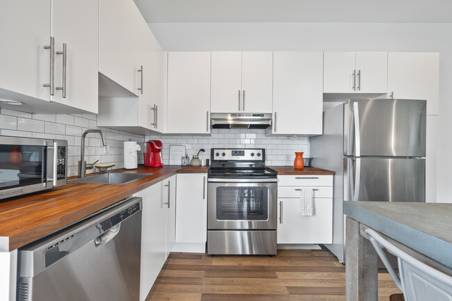 Kitchen is fully equipped with appliances including a large fridge, stove, and coffee station. It is - 906 Allene Ave SW