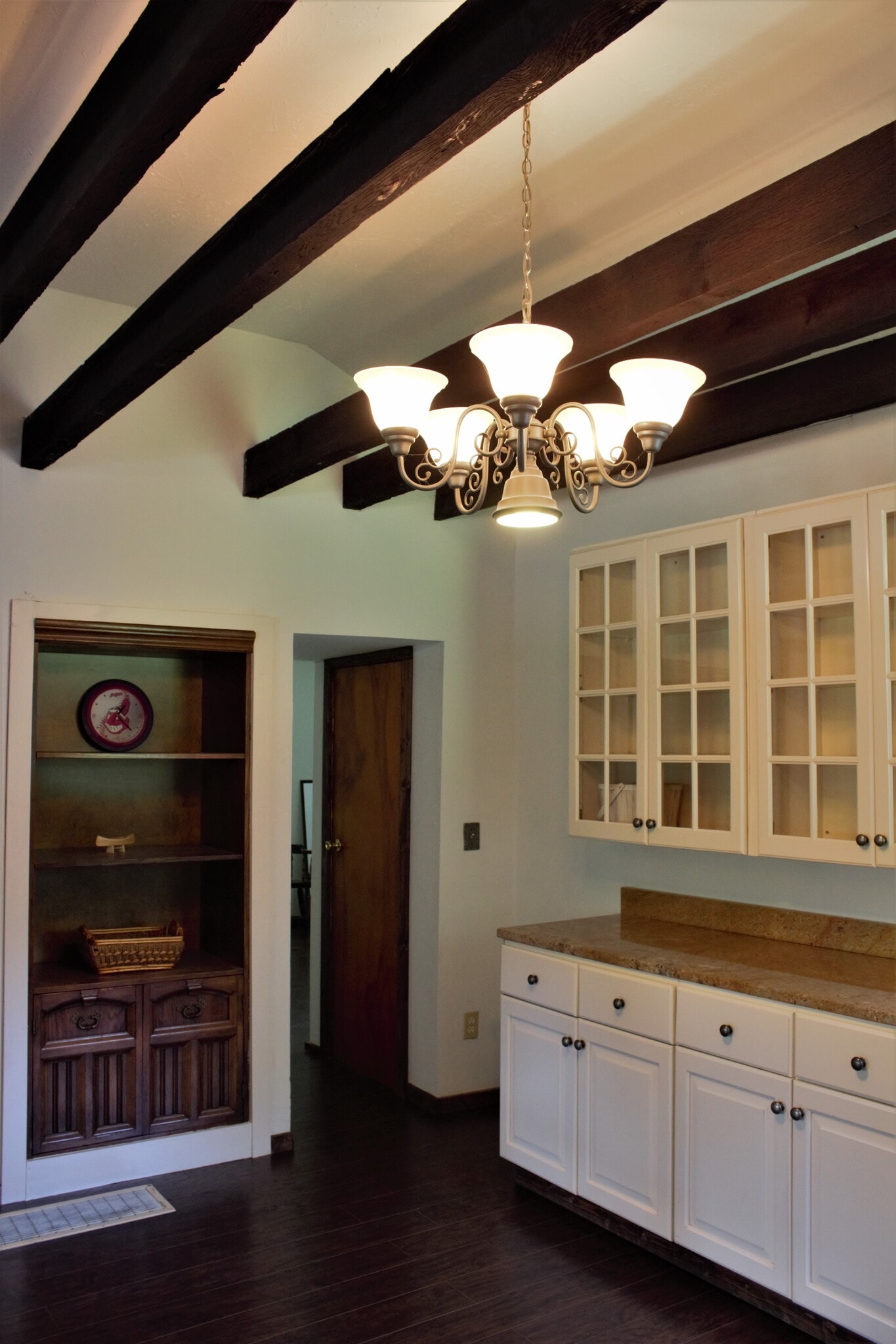 Dining area. Original 1860 beams in ceiling. 6-light chandelier. Glass panes on cabinets, granite counter. - 9331C Tallmadge Road