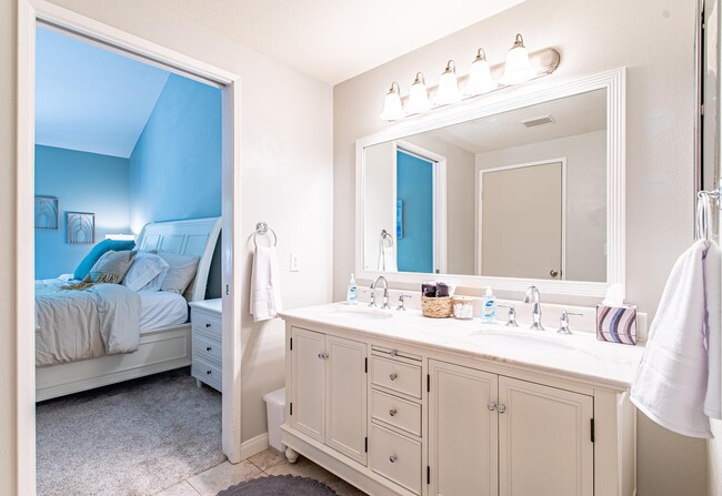 Double-sink bathroom with large, well-lit mirror enables you to look your best in your new community - 24137 Del Monte Dr