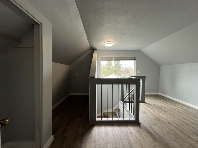 Building Photo - Three-Bedroom Home with Updated Kitchen & Vaulted Ceilings, large open basement, Hardwood floors
