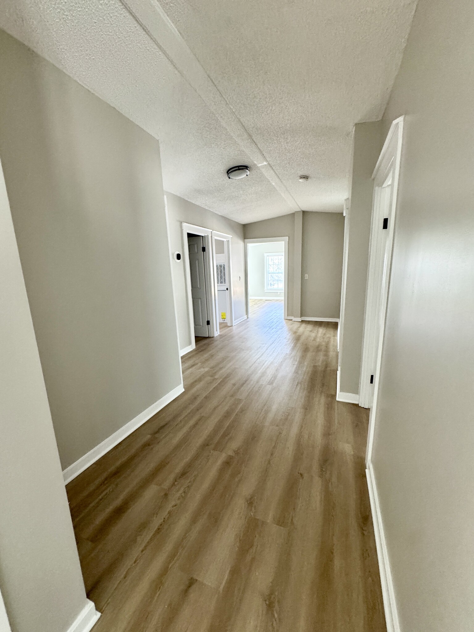 Hallway to other bedrooms and bonus - 525 Horsefly Rd