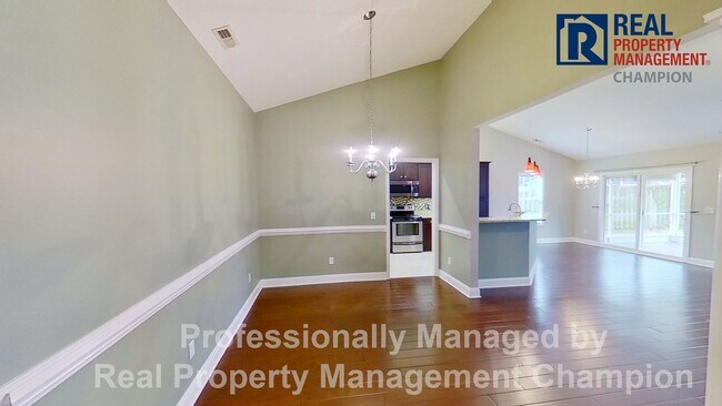 Building Photo - Beautiful home boasts open floorplan, screened porch, and spacious fenced yard