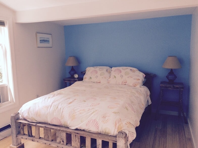 Master bedroom with handmade driftwood bed and nightstands - 403 Ferry Road
