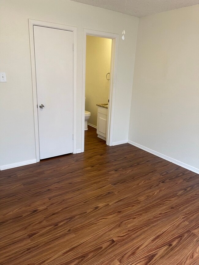 Building Photo - MOVE-IN READY. Single level, pet friendly front-end fourplex townhome, UPGRADED WIDE PLANK FLOORI...