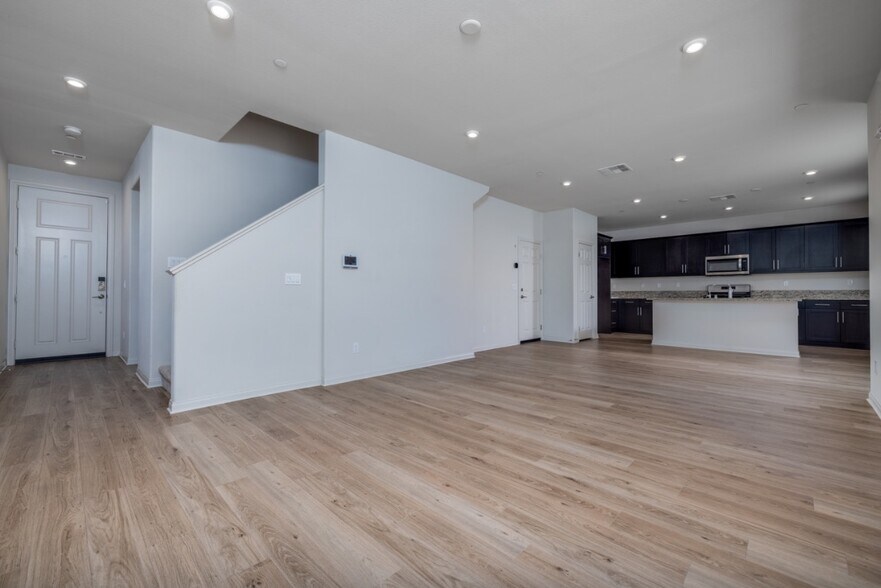 Open-concept living area with laminate flooring, recessed lighting, and easy flow to the modern - 26549 Brightstone Dr