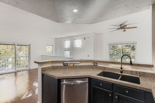 Building Photo - Light-Filled Corner Condo with Garage + Covered Parking in Gated Community