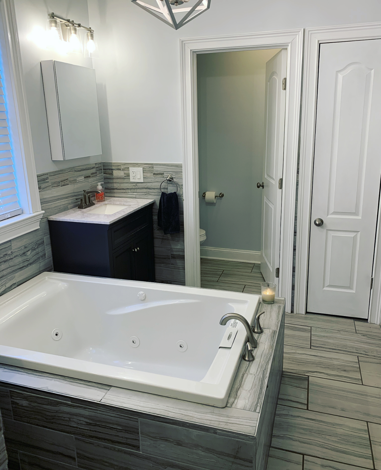 Upstairs full bath with two sinks, jetted soaking tub, and private toilet room. - 74 Peters Pl