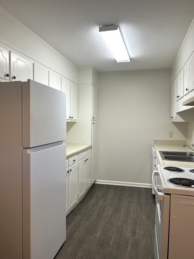 Galley style kitchen with plenty of counter space and cabinet storage - 219 H Northpoint Avenue