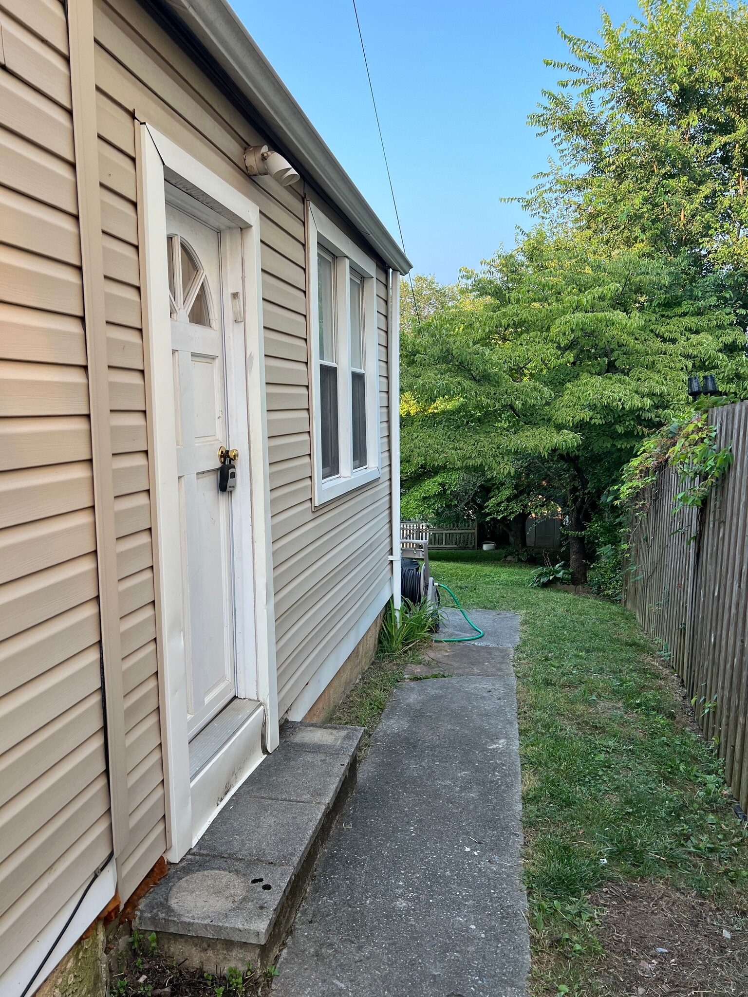 A view of the mudroom side door and sidewalk leading to the deck and backyard. - 126 Merion Ave