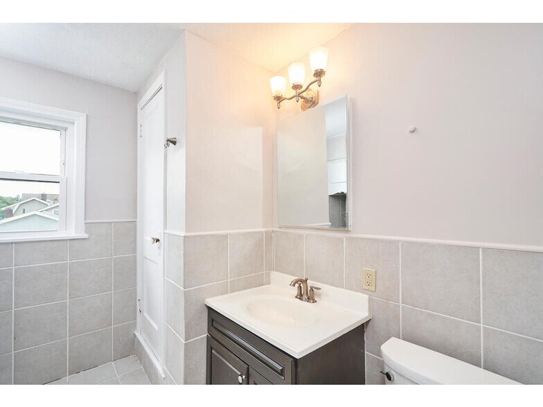 Full Bath has a built-in vanity, cupboards and linen closet for storage, and tub/shower combo. - 1214 Beardsley St