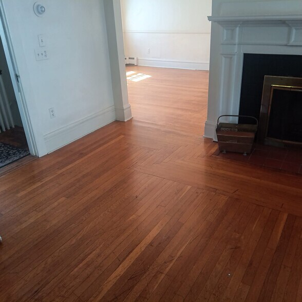 Hardwood floors/working fireplace/living room looking towards dining room - 29 Ogden St