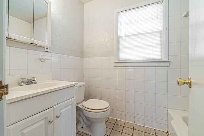 Building Photo - Three Bedroom Home in tree filled neighborhood! Lawn care included!