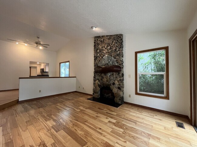 Building Photo - Spacious 3-Bedroom Home with Custom Stone Fireplace, Attached 2-Car Garage & Expansive Backyard i...