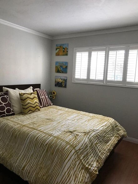 New windows and door walls with shutters and drapes in living room included - 6111 Rancho Mission Rd