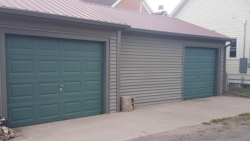 Two car garage with automatic doors and a garage door on the other side so you can pull all the way through to the backyard if you need to. - 407 S. 6th Street