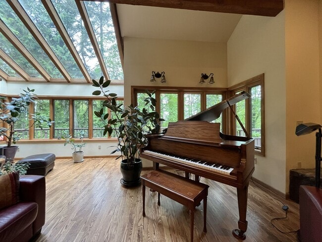 Building Photo - One-of-a-Kind Custom Home with Wall of Windows, Stone Fireplaces, Expansive Entertainment Space &...