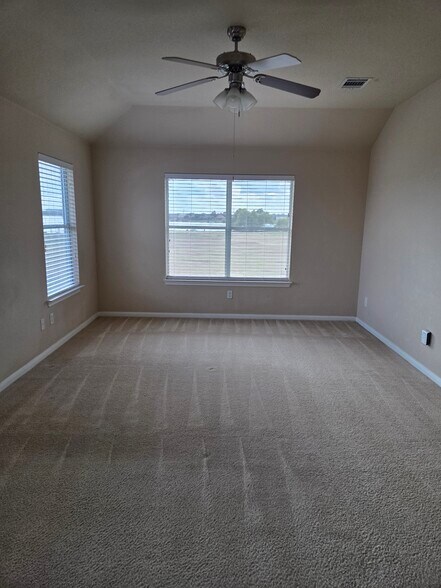 Primary bedroom with double windows facing lake - 18204 Kermit Ct