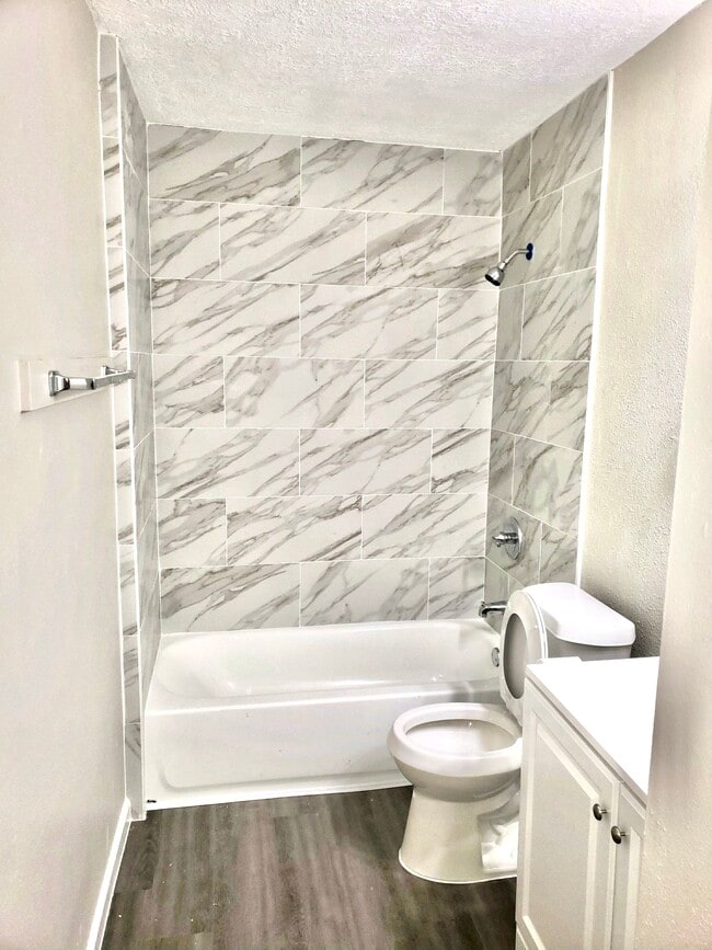 Secondary bathroom with new tub, sink, vanity, and toilet - 10015 Valley Lake Dr