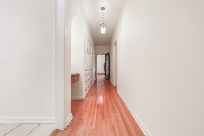 Hallway From Bedrooms Towards Entrance - 139 N Orange Dr