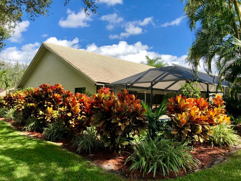 Tropical landscaping at side and back of home - 2662 NW 42nd St