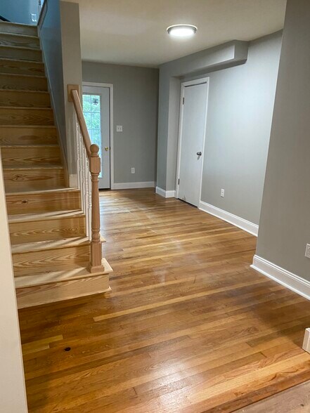 Living room with original hardwood floors refinished in 2022. - 3054 S Pike Ave