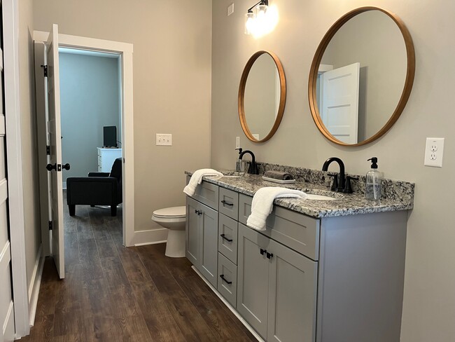 Spacious bathroom with dual sink vanity, large tiled walk-in shower - 513 S Main St