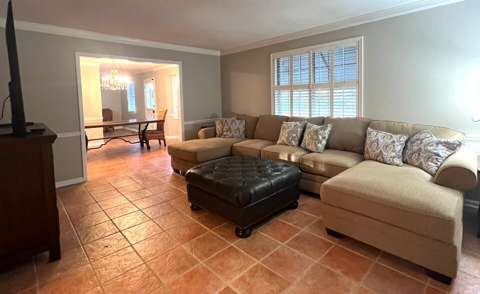 Large living room with comfy sectional sofa, large ottoman, and 70 inch - 902 Penn Waller Rd
