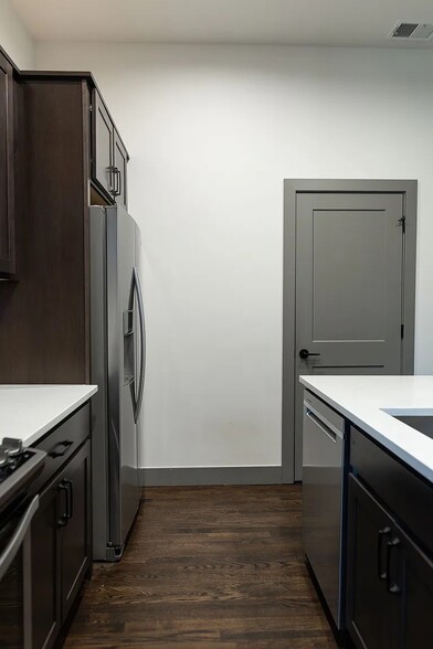 Full kitchen with stainless steel appliances, including a microwave, gas range, dishwasher, & fridge - 3505 S Marion St