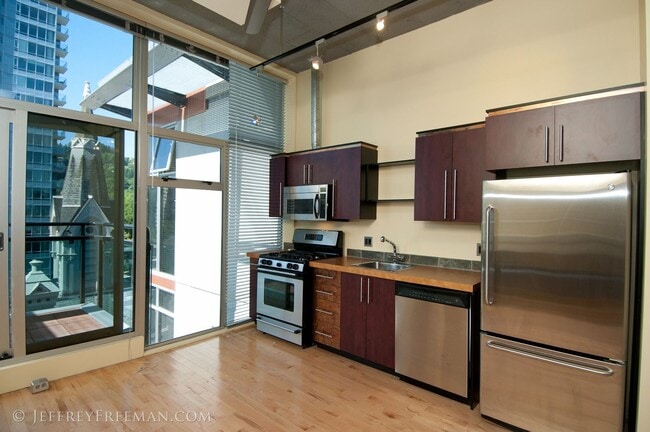 Building Photo - Stunning Penthouse Loft in the Mosaic Condos - Gas Fireplaces, A/C, W/D in unit!