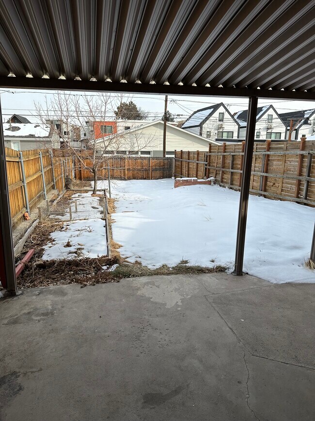 covered patio. Under snow is a flagstone sitting area - 3628 Mariposa St