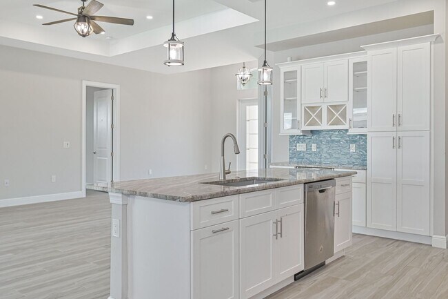 Building Photo - NOW AVAILABLE - Gorgeous Pool Home ~ NW Cape ~ 3 Car Garage ~ On Canal!