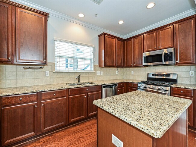 Building Photo - Stylish Condo Living with Open Concept, Garage & Outdoor Space