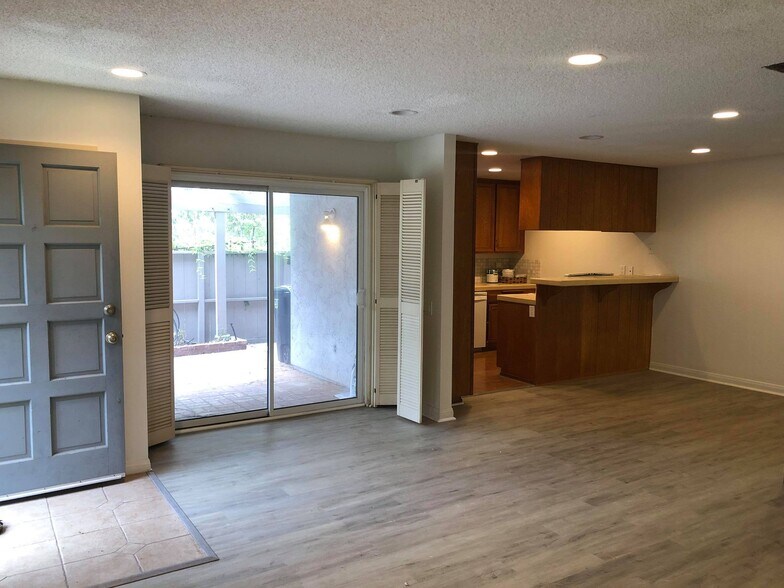 Living room; entrance to the far left, door to patio on the left, kitchen on the right - 9594 Easter Way