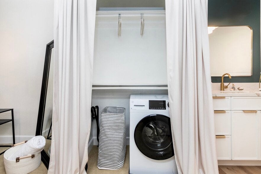 In-unit GE washer/dryer combo with hanging and shelf storage. - 2221 Ocean Ave