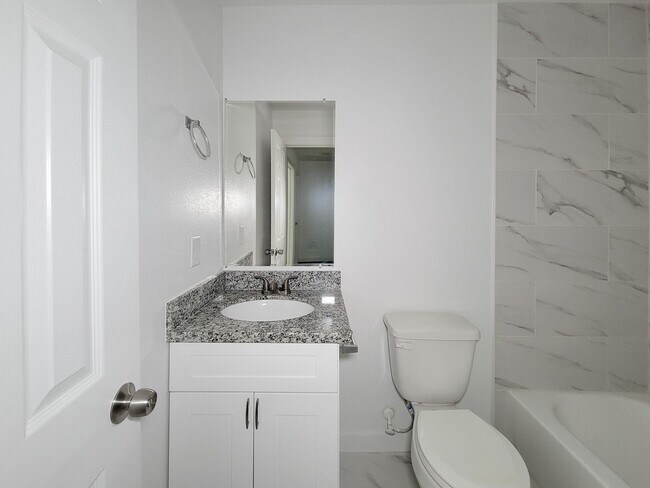 Building Photo - This newly constructed 3-bedroom, 2-bathroom unit offers modern living with 1,150 sq ft of space....