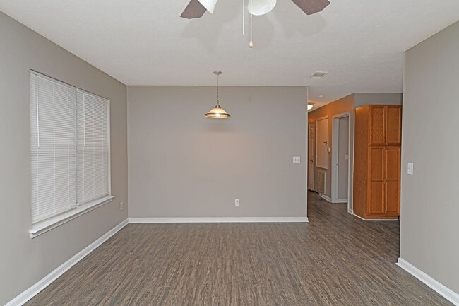 Spacious living room with hardwood-style flooring - Prairie Creek Estates