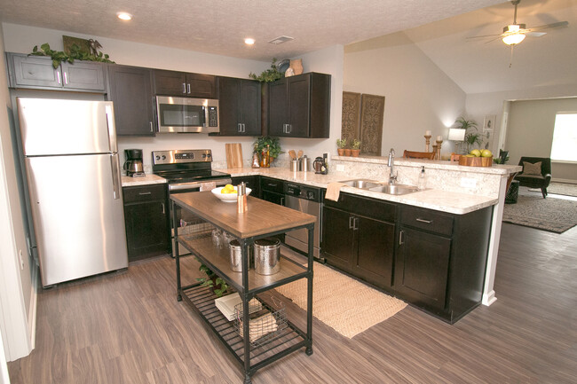 luxury vinyl wood-plank flooring, stainless steel appliances, attached two-car garage - The Residences at Woodside