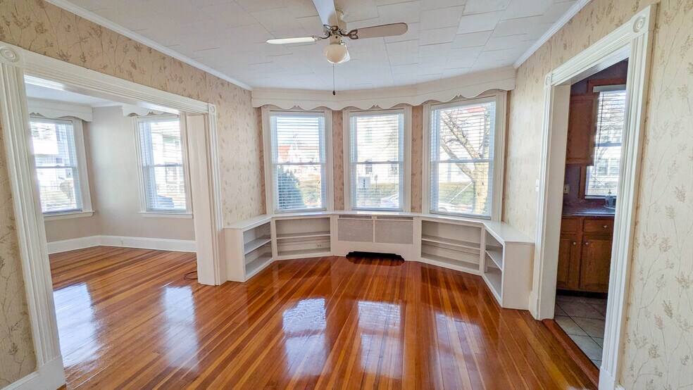 Spacious dining room with charming built-in bookshelves, offering flexibility for hosting or a dedic - 37 Glover Ave