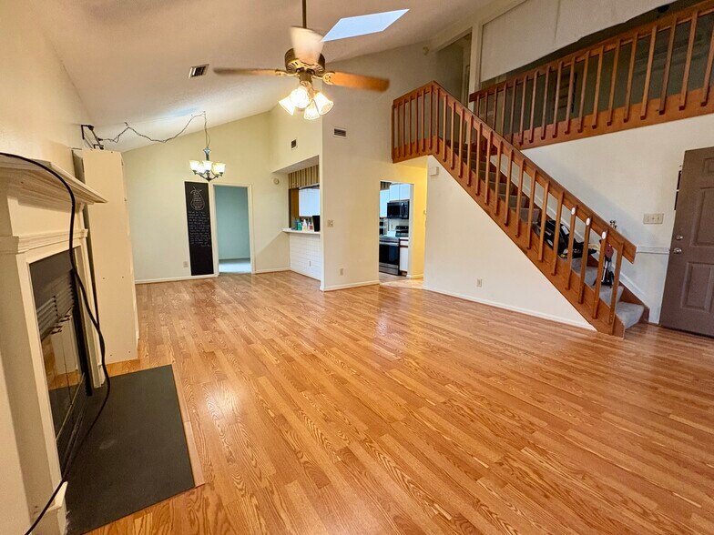 View of great room with fireplace, stairs, loft, and kitchen/hallway - 208 Quarter Trl