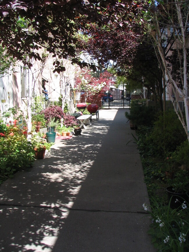 Patio with tenants' barbecues, chairs, tables and plants - 1624 T St
