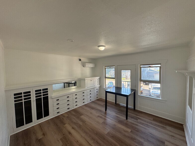 Living room with murphy bed pulled up - 420 E 14th St