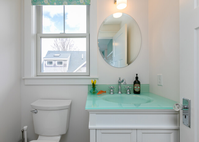 First floor powder room features a unique and beautiful glass sink. - 11 Henry St