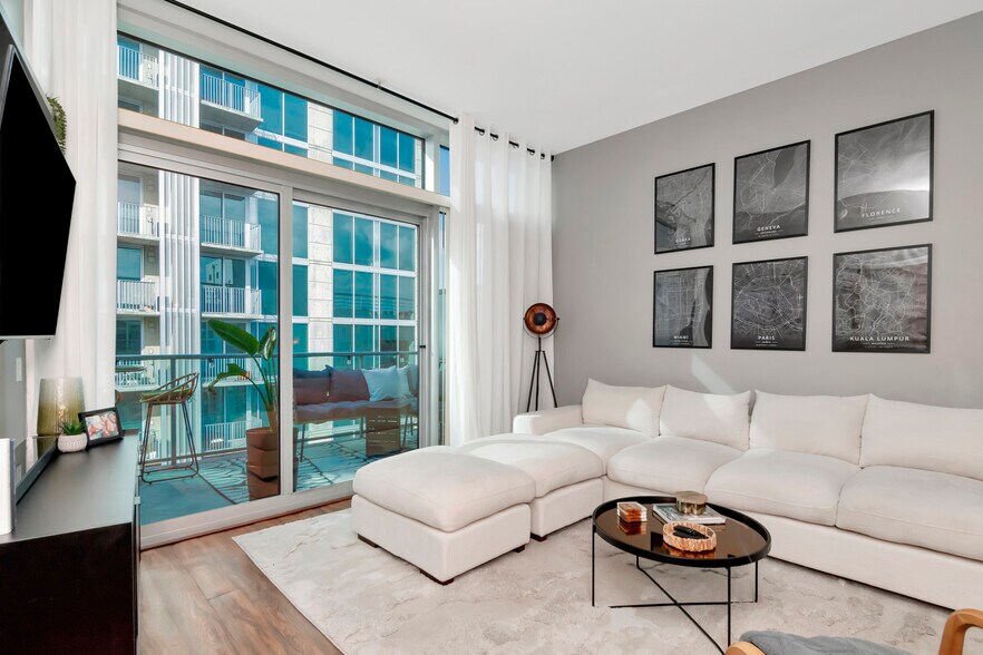 Living Room with floor to ceiling windows and beautiful top floor sunlight - 111 N 12th St