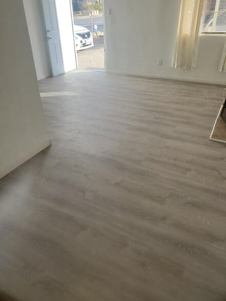 Brand new laminate plank flooring in living area & bedroom - 6432 Smoketree Ave