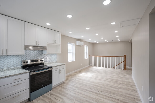 4BR, 2BA - 1,358SF - Kitchen/Living Room - Ivy Court Apartments